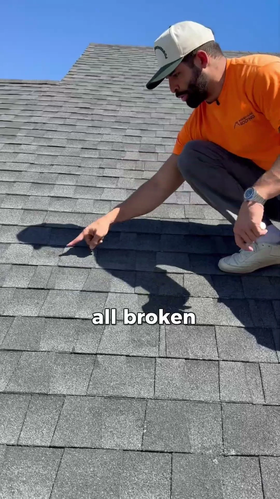 PowerHouse Roofing team member pointing out broken shingle edges during a September roof inspection in Utah
