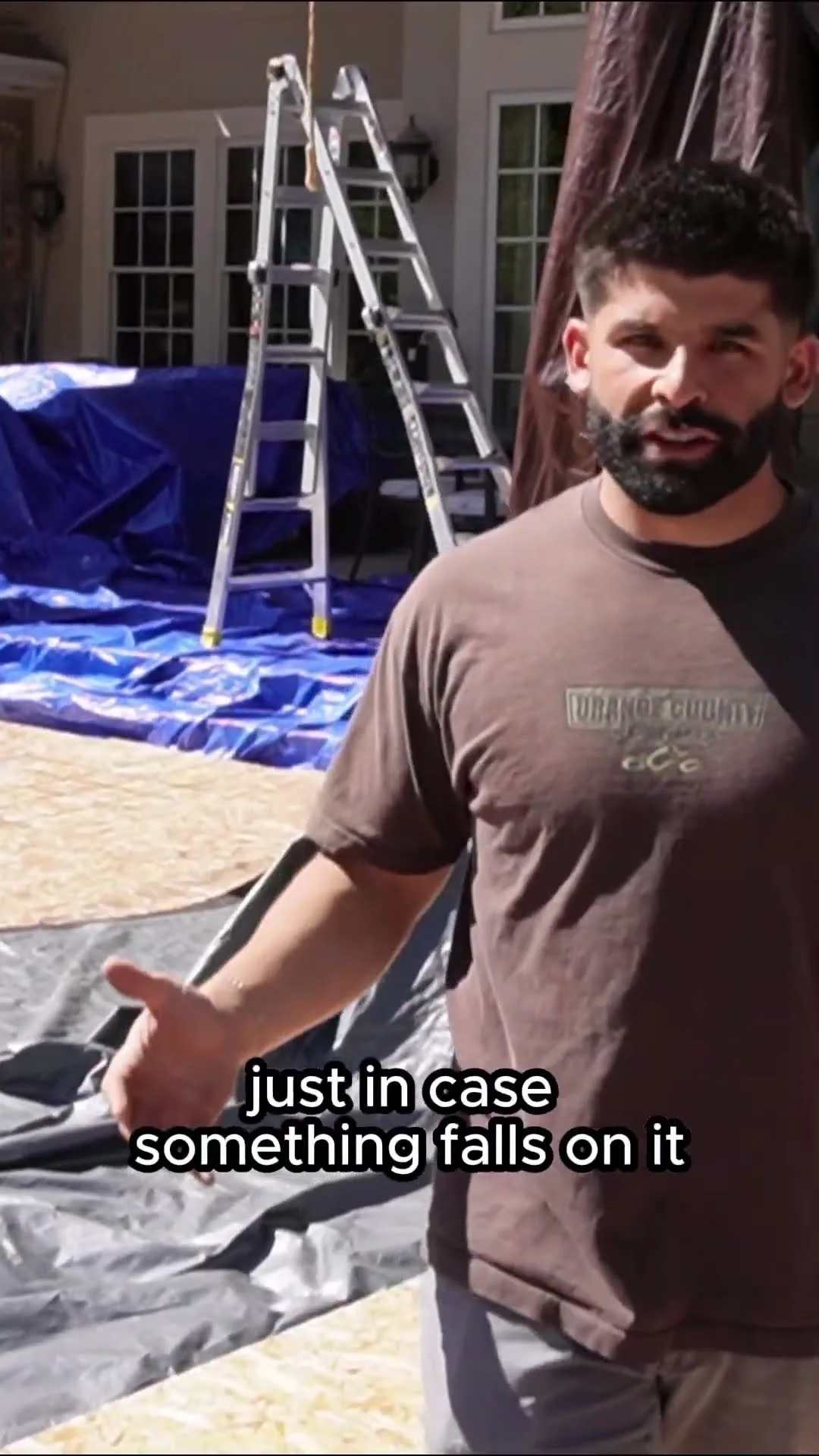 PowerHouse Roofing team member showing protective coverings used around a Utah exterior project