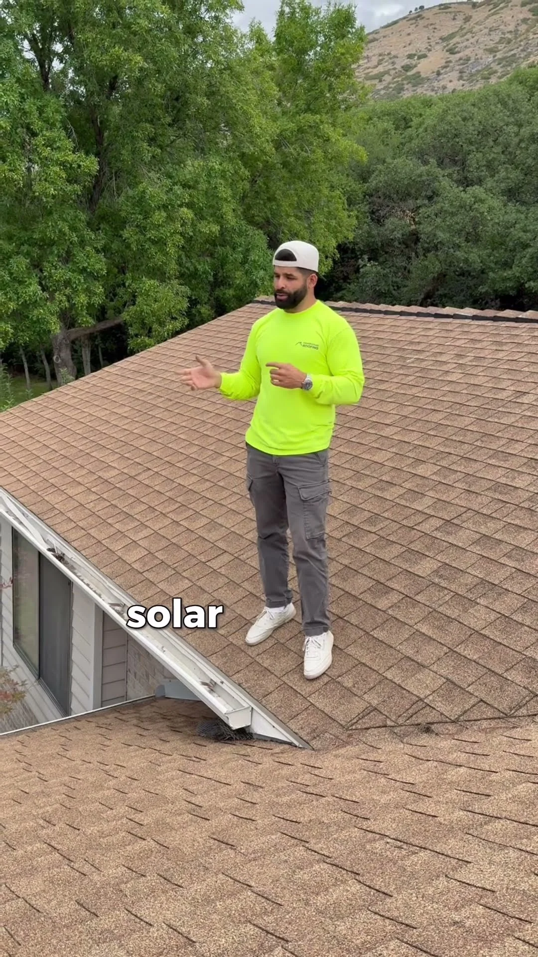 PowerHouse Roofing team member discussing roof condition before solar work on a Utah home